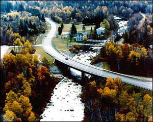 overhead view of the Pierce Bridge along U.S. Route 302 in New Hampshire spanning a river with treelined banks