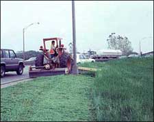 Photo of a roadside being mowed