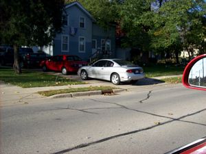 Car Parked Across Sidewalk