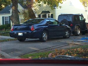 Car Parked Across Sidewalk