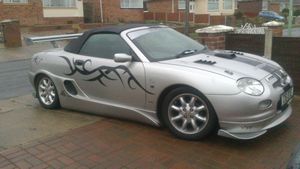 MGF, lowered, flamed and spoilered.  Badass