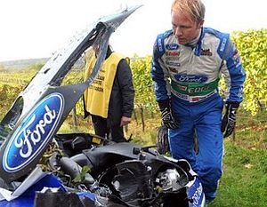 Petter Solberg surveying his broken Fiesta WRC