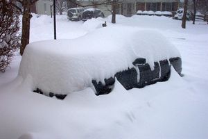 Automobile being covered by snow