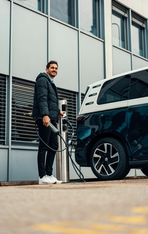 Man Charging Van with Juice Cable