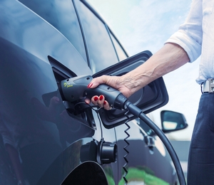 Woman Charging Car with Juice Station