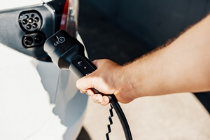Man Plugging Juice Cable in to Car