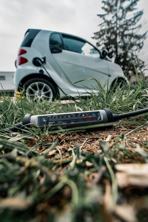 Juice Cable on Ground Next to Smart Car