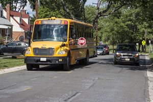Car Passing School Bus with Stop Sign Out